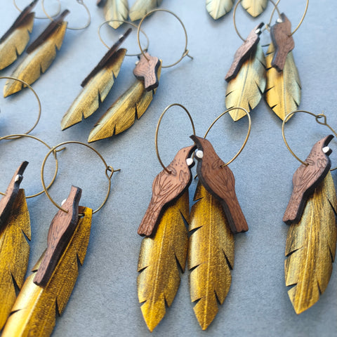 Tui on Gold feather earrings